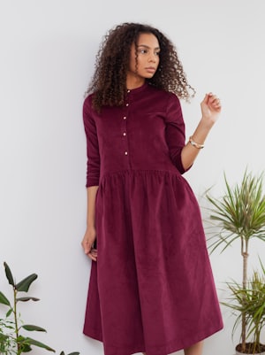 Woman in an elegant long maroon dress